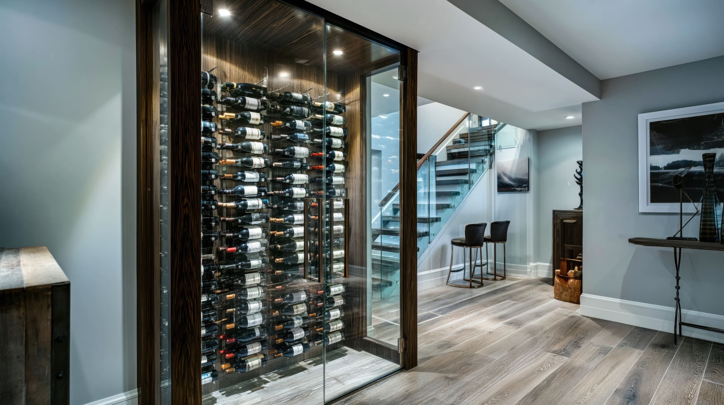 Compact glass wine cellar set into a lower-level hallway